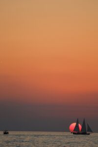 sailboat on water at sunset